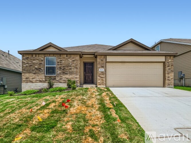 A house with a brown garage door and a brown stone wall.