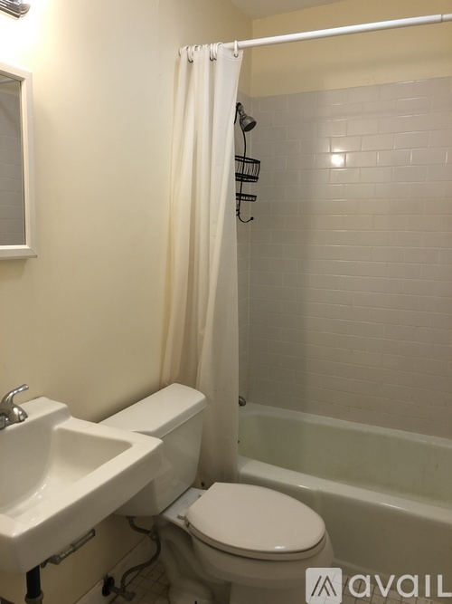 A white toilet is next to a sink in a bathroom.