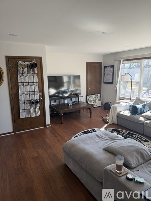 A living room with a grey couch and a coffee table.