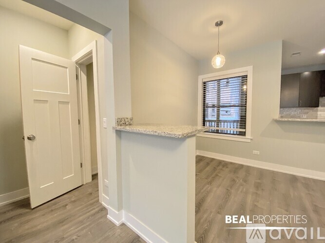 A white door is on the left and a window with blinds is on the right.