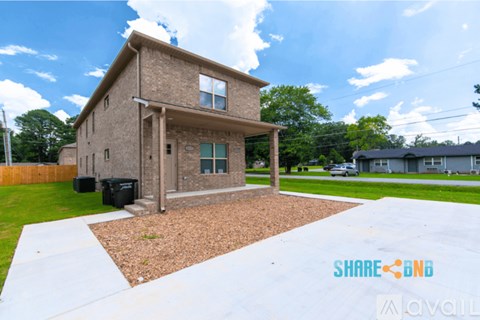 A house with a brown roof and a white fence is shown.