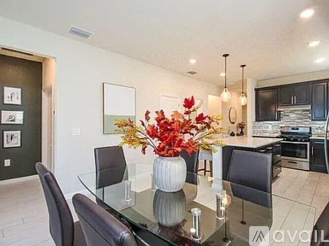 A modern dining room with a glass table and chairs.