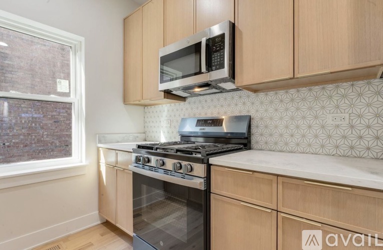 A kitchen with a stove top oven and microwave above it.
