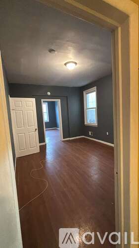 A room with wooden floors and a white door.