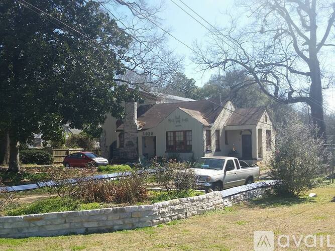 A house with a car parked in front of it.