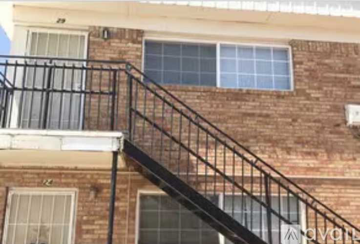 A brick building with a metal staircase.
