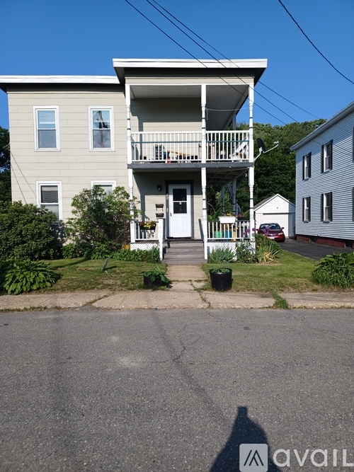 A two-story house with a white front porch.