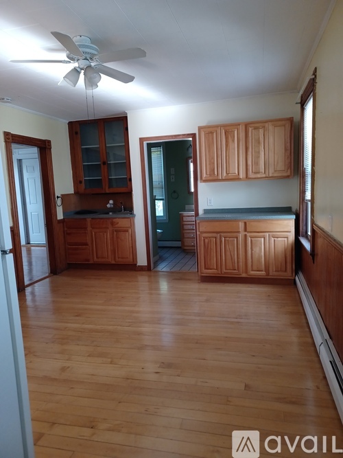 A room with wooden floors and a ceiling fan.