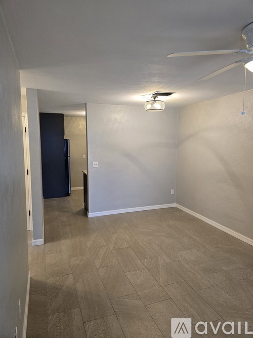 A room with a ceiling fan and a light fixture.