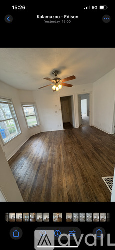 A room with wooden flooring and a ceiling fan.