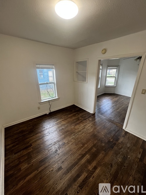A room with wooden floors and a window.