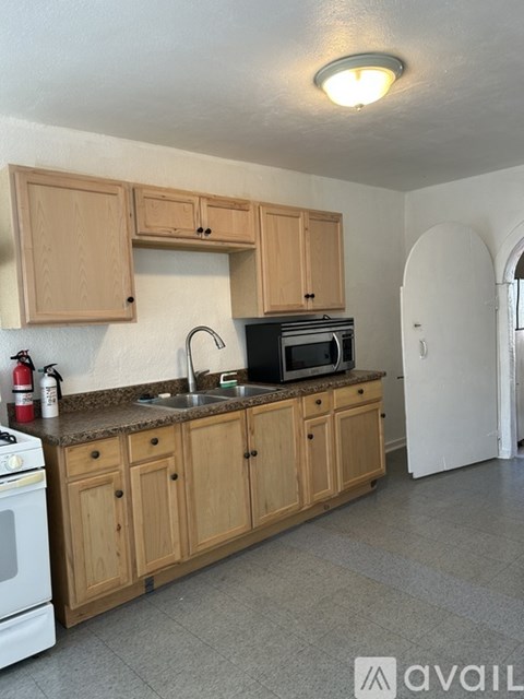 A kitchen with wooden cabinets and a white oven.