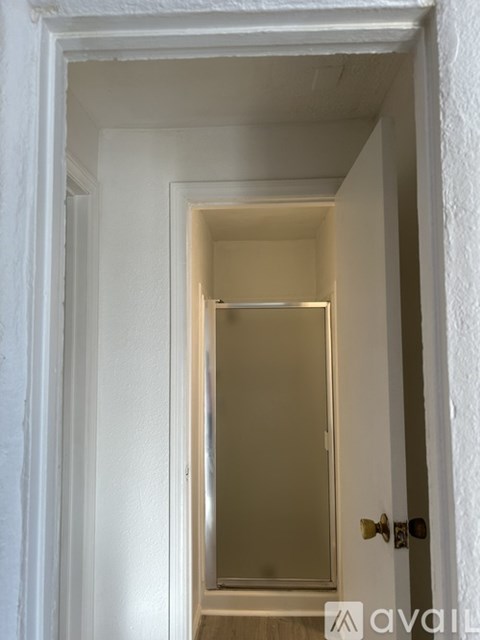 A white door with a mirror on the other side.