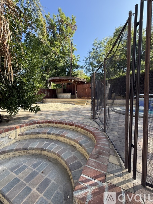 A backyard with a pool and a fence.