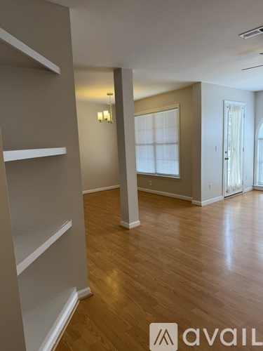A room with wooden floors and white walls.
