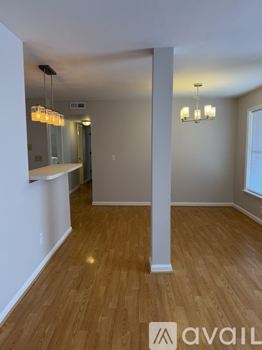 A room with wooden floors and a chandelier.
