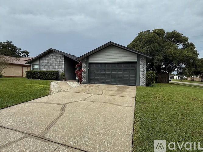 A house with a grey garage door is for sale.