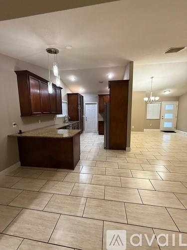 A kitchen area with a counter and cabinets.