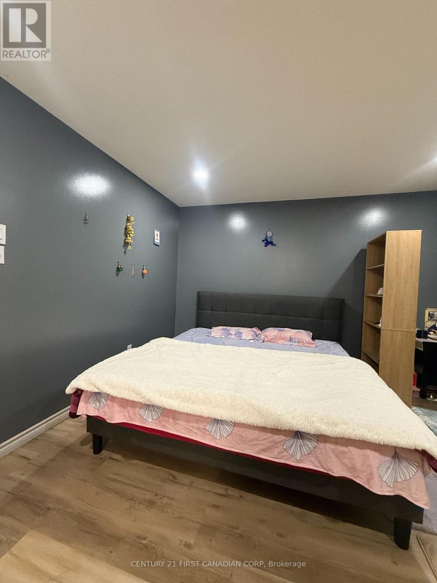 A bedroom with a bed and a wooden shelf.