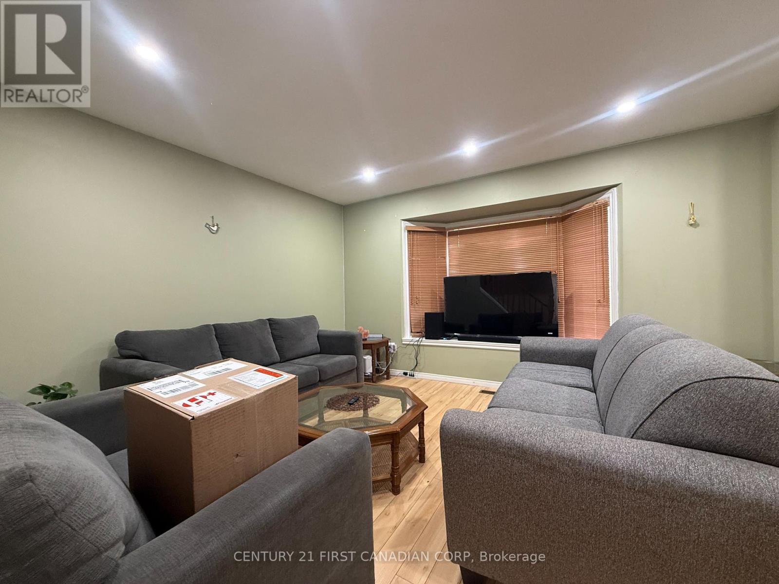 A living room with grey couches and a coffee table.