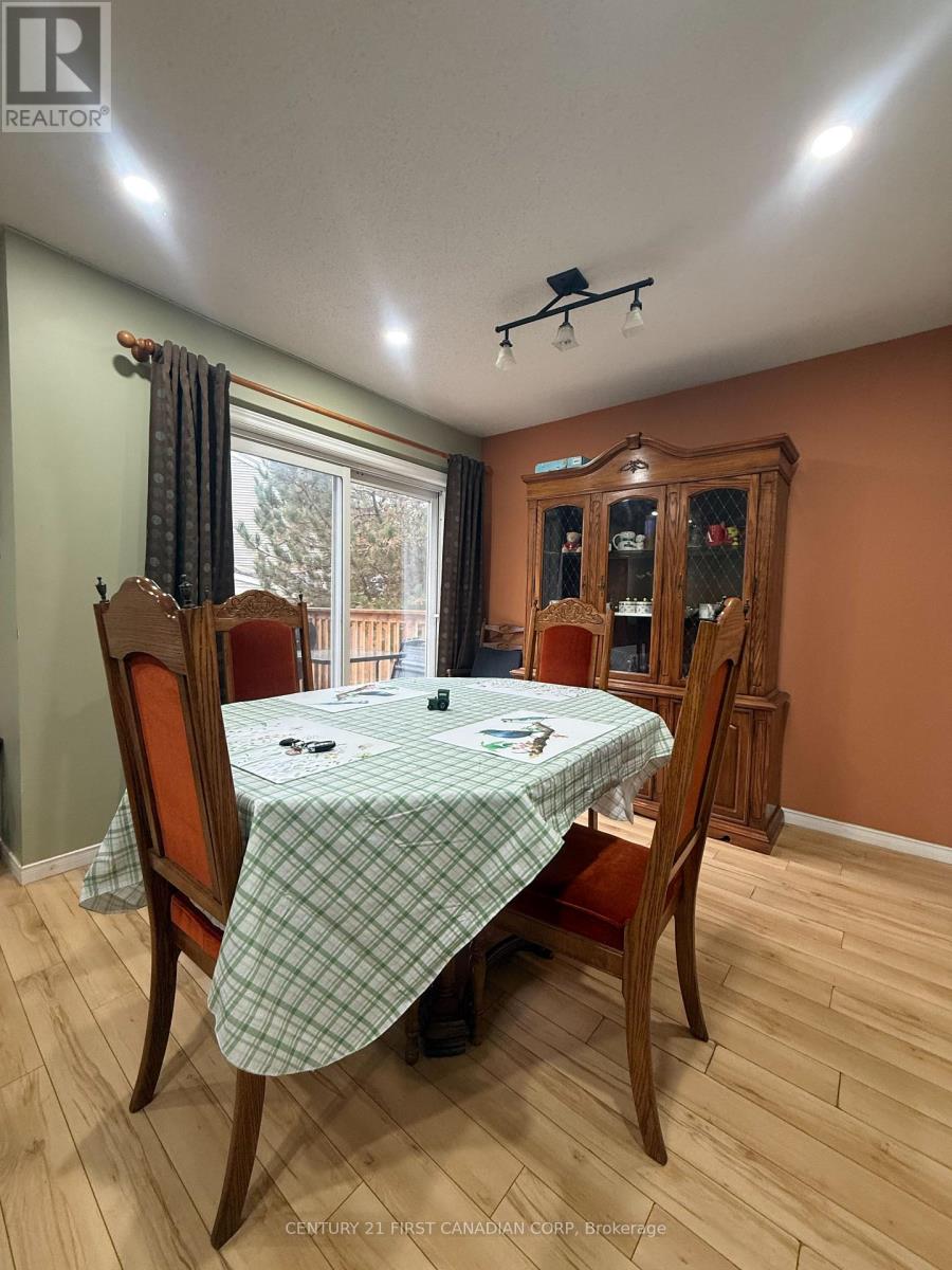 A dining room with a table set for four.