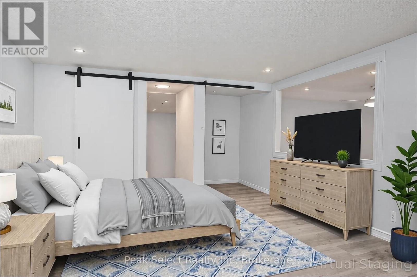 A bedroom with a bed, dresser, and a television.