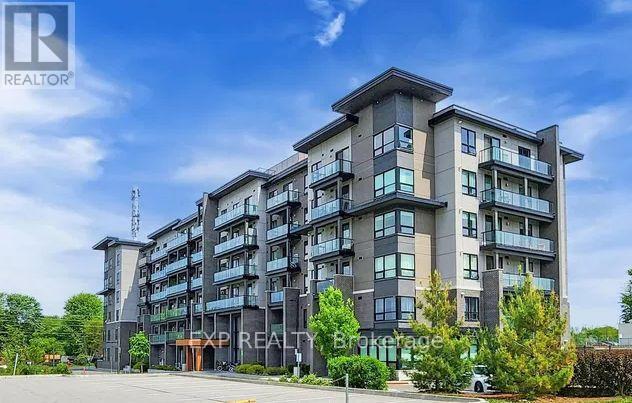 A large, modern apartment building with a sign that reads "REALTOR" in the foreground.