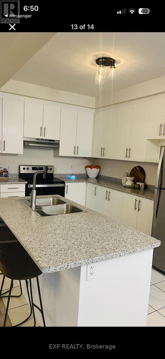 A kitchen with white cabinets and a granite countertop.