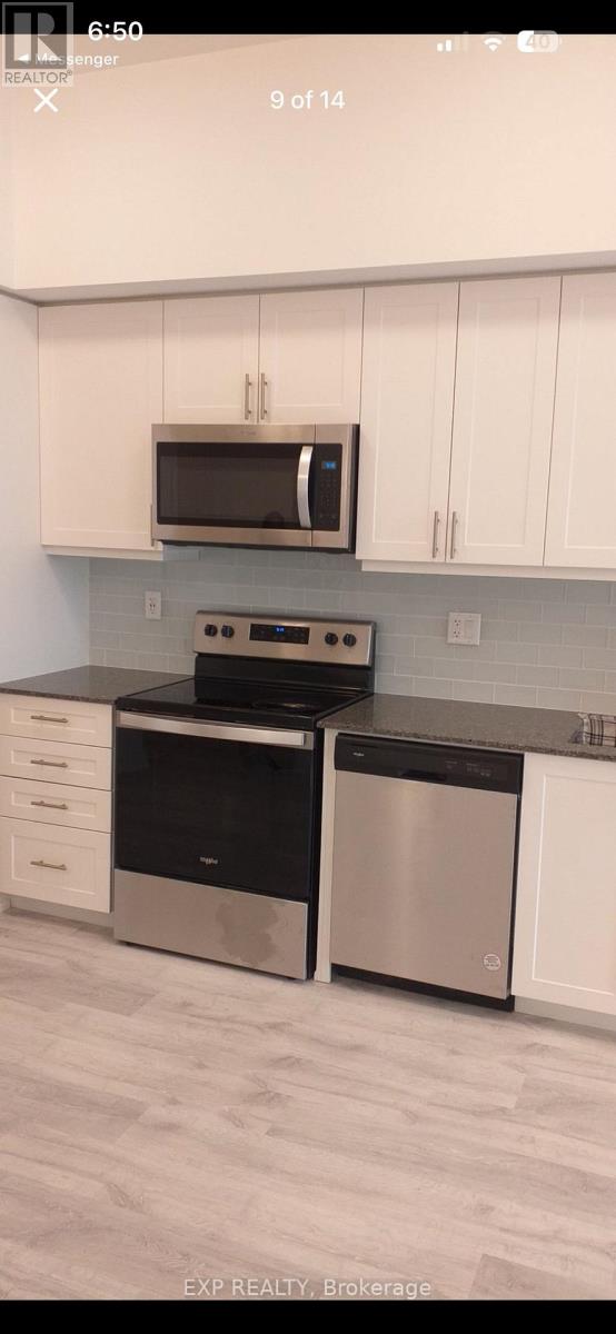 A kitchen with white cabinets and a black stove top oven.