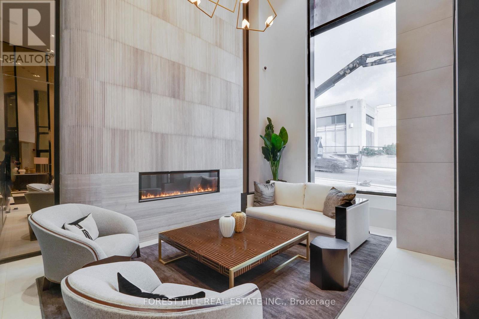 A modern living room with a fireplace and a large window.