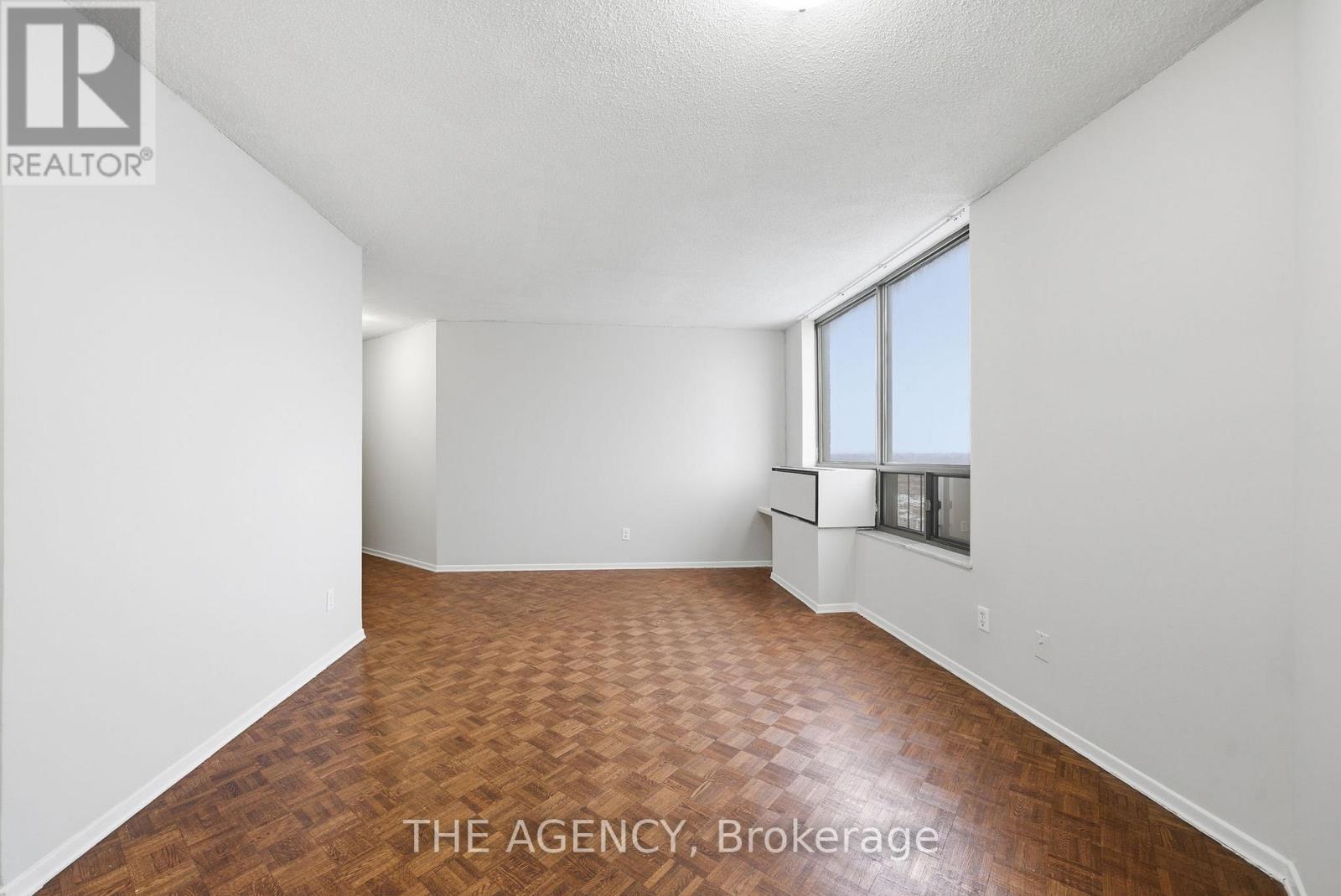A room with a wooden floor and white walls.