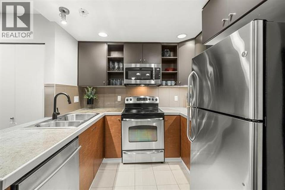 A modern kitchen with stainless steel appliances and wooden accents.