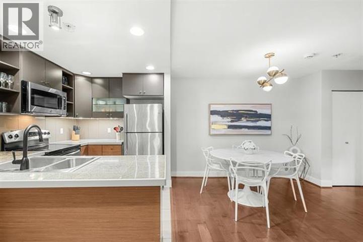 A modern kitchen with a dining table and chairs.