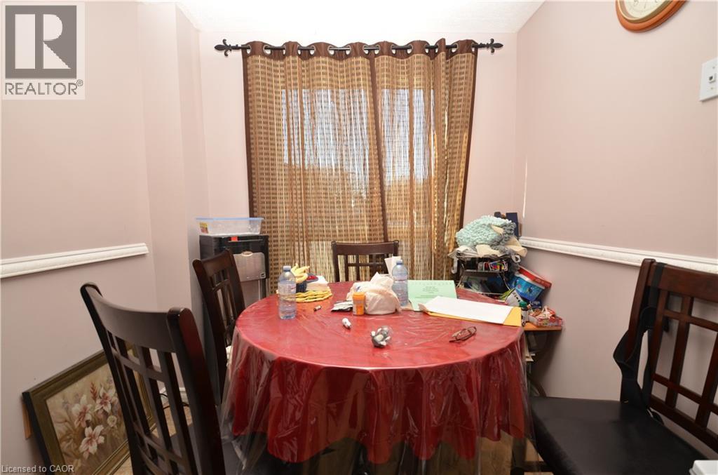 A dining room with a table set for a meal.