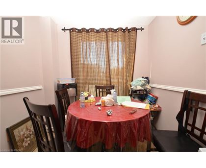 A dining room with a table set for a meal.