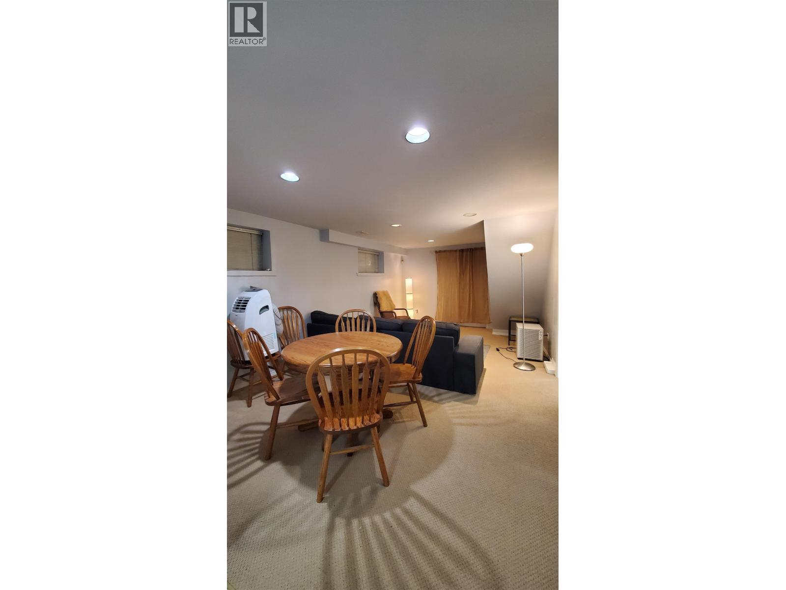 A room with a table and chairs in it.