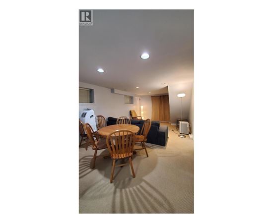 A room with a table and chairs in it.