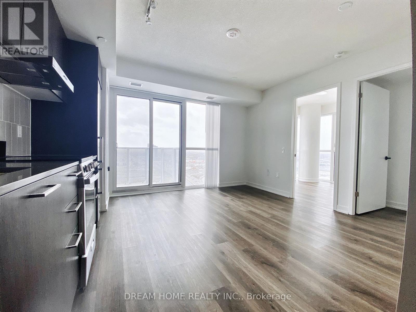 A spacious kitchen with dark blue cabinets and a white countertop.