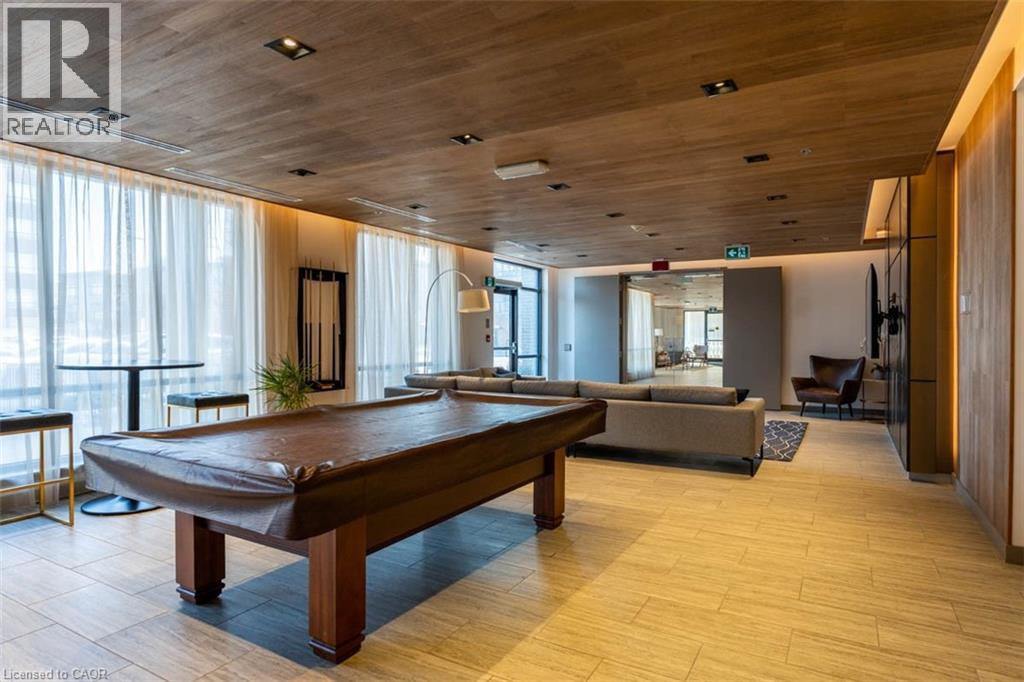 A pool table in a room with a wooden floor and ceiling.
