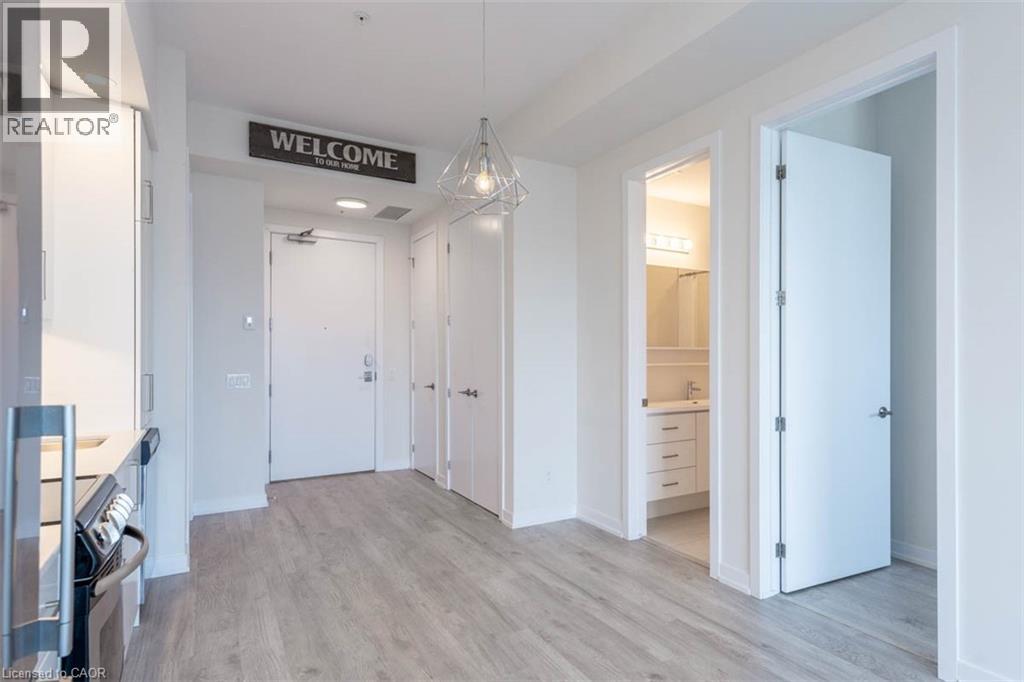 A realtor sign is on the wall of a spacious, empty apartment.