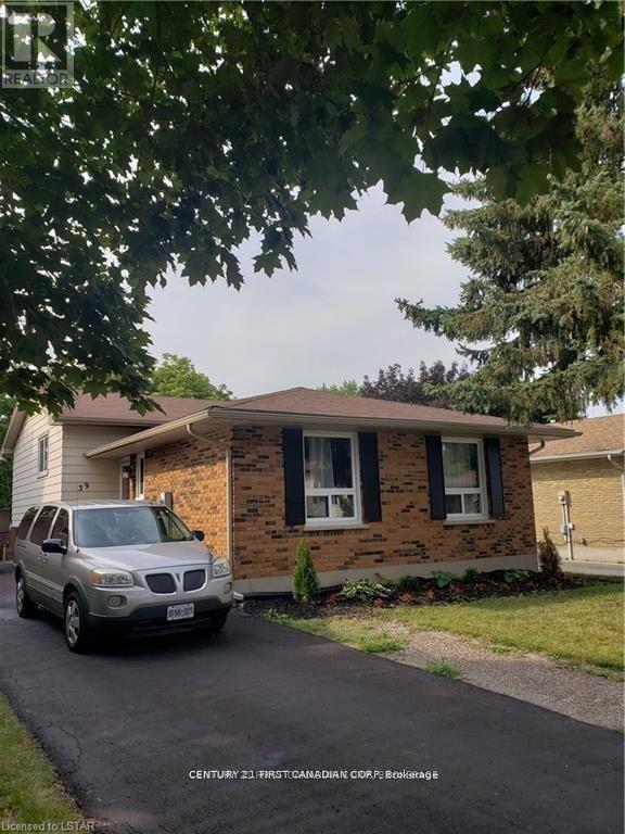 A house with a car parked in front.