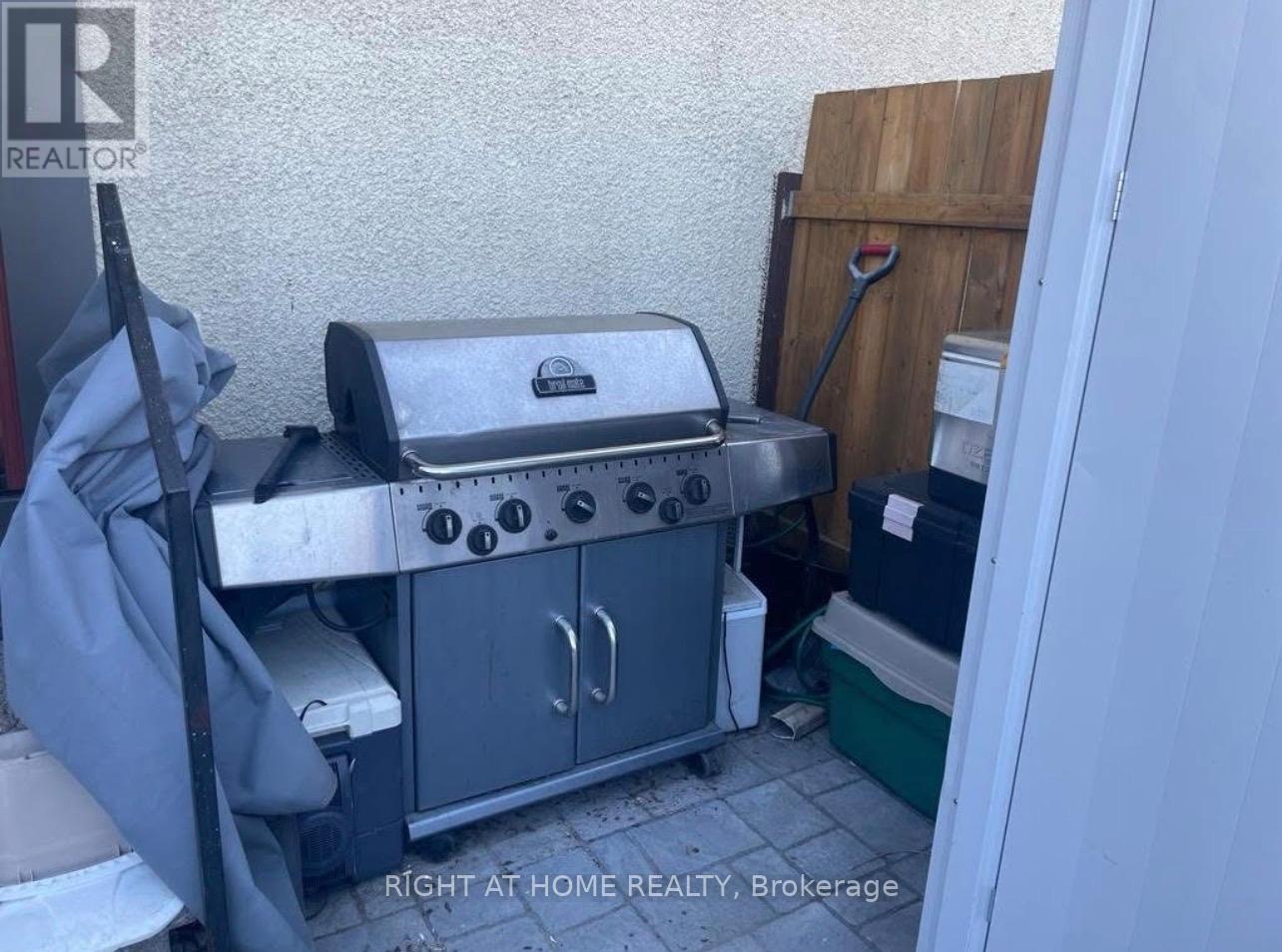 A grill is in a small outdoor space.