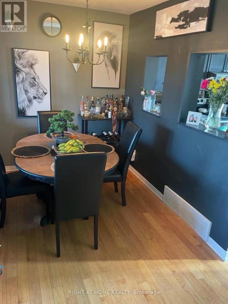 A dining room with a table set for two and a bar area in the background.