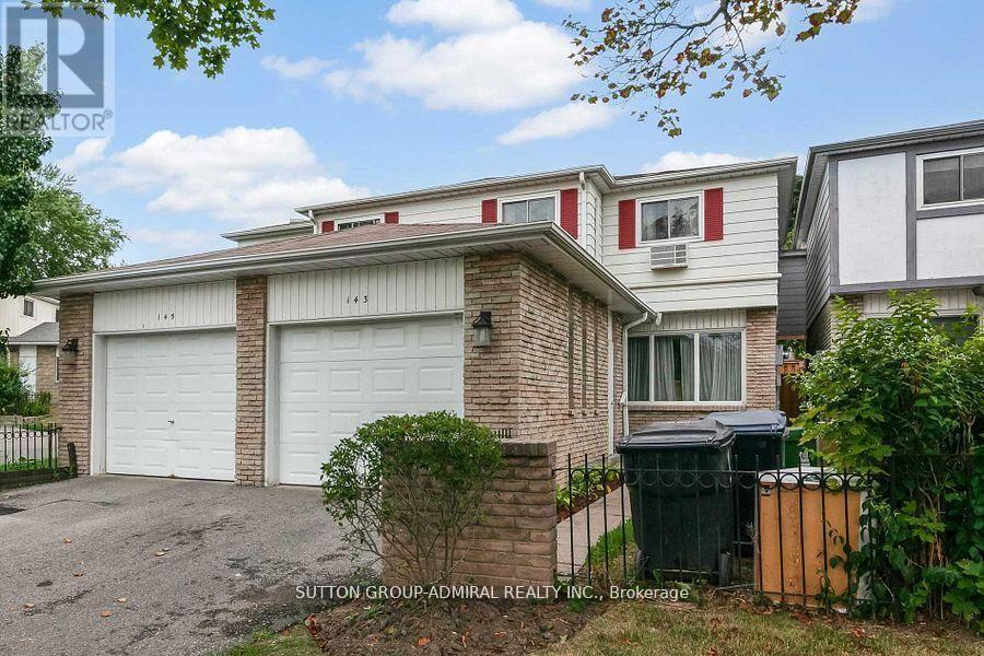 A house with a red stripe on the window and a garage door.