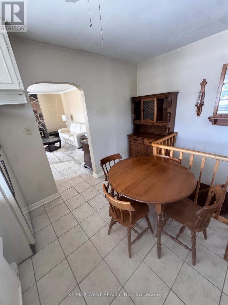 A dining room with a wooden table and chairs.