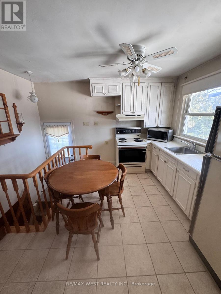 A kitchen with a table and chairs.