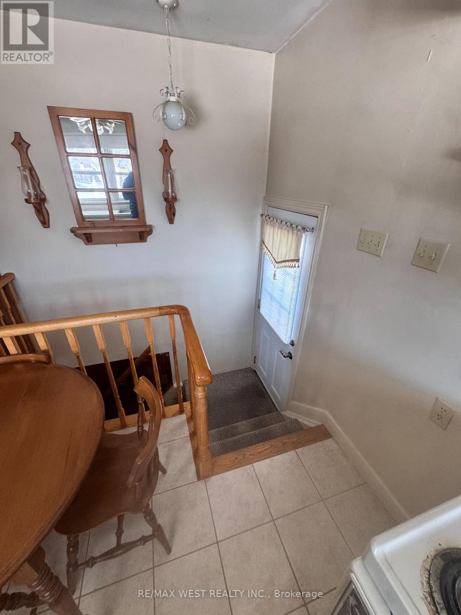 A white wall with two windows and a light fixture.