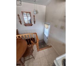 A white wall with two windows and a light fixture.