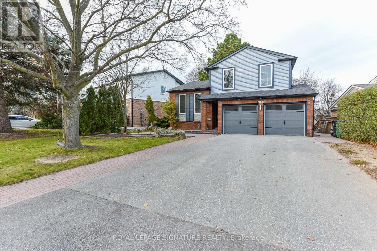 A house with a grey roof and a grey garage door.