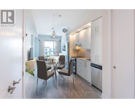 A modern kitchen with a dining table set for four.